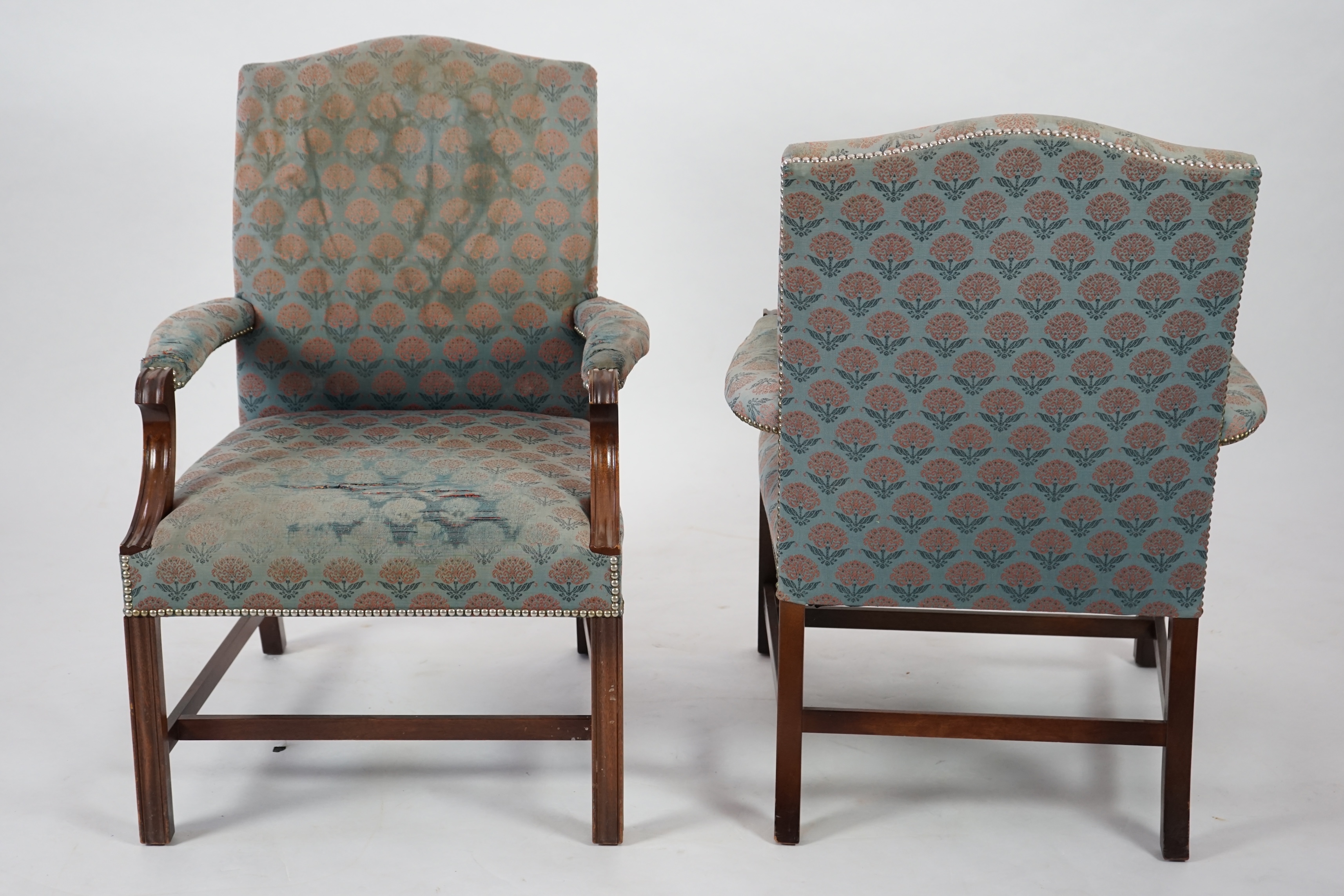 A pair of Thomas Glenister George III style mahogany Gainsborough armchairs